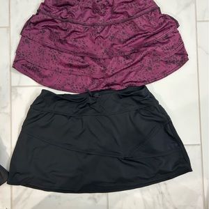 2 Athleta size small skirts one is black and one is maroon with black .